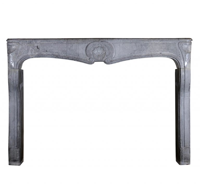 A Louis XV Franche Comte Hardstone Fireplace Surround