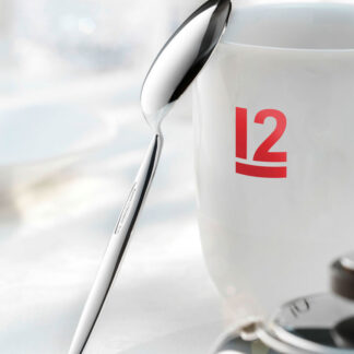 12” Kaffeelöffel_125DPI Robbe & Berking 12 spoon resting on white mug