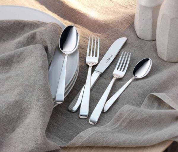 Robbe & Berking Silver Flatware lifestyle photo featuring the Alta pattern on tablecloth.