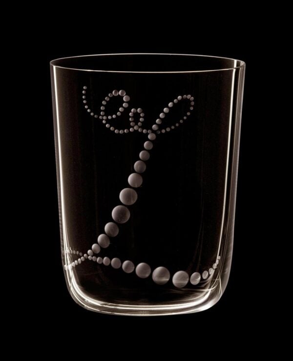 Lobmeyr Drinking Set no. 4 Monogrammed Tumbler. Monograms designed by Ted Muehling mood shot with black background.