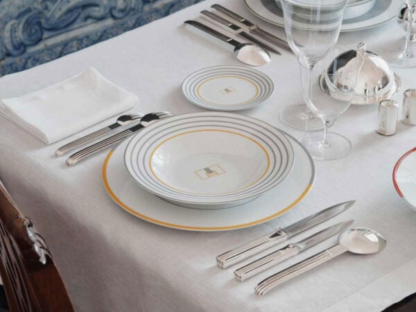 PUIFORCAT-MOOD-Collection-Monogrammes-Deauville-1200w-100KB Puiforcat Deauville in Sterling Silver Place setting LIfestyle Photo pictured with Puiforcat Monogram Dinnerware and Lobmeyr Patrician Stemware | Kneen & Co