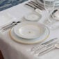 Puiforcat Deauville in Sterling Silver Place setting LIfestyle Photo pictured with Puiforcat Monogram Dinnerware and Lobmeyr Patrician Stemware | Kneen & Co