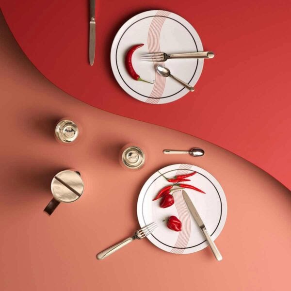 A Table Setting with Puiforcat Initiales Dinnerware with Normandie Cutlery.
