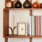 Puiforcat Ruban Silver Photo Frame on a bookshelf | Kneen & Co