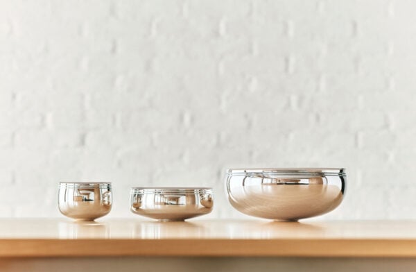 PUIFORCAT-MOOD-Collection-Selene-4-1200w-100KB A lifestyle photo of the Puiforcat Selene Collection featuring the 3 sizes of sterling silver bowls on a shelf.