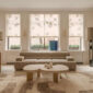 A lifestyle photo of the Puiforcat Selene Collection including sterling silver bowls and vases. 2 Selene Bowls and a vase are pictured on a coffee table in a living room.