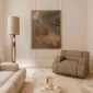 A lifestyle photo of the Puiforcat Selene Collection including sterling silver bowls and vases. 2 Selene Bowls and a vase are pictured on a coffee table in a living room.