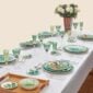 Puiforcat Royal Sterling Silver Flatware pictured with Hermes Passifolia Dinnerware and Saint-Louis Crystal Tommy Stemware in colored greens.