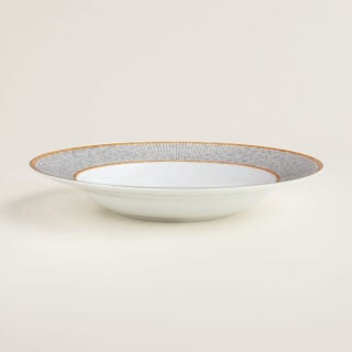 Hermes Mosaique au 24 Gold Rim Soup Plate shown on table | Kneen & Co