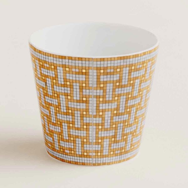 HERMES-DNRWR-Mosaique-au24-Or-026040P-worn-1-1200x1200px-100KB Hermes Mosaique au 24 Gold Tumbler shown on table | Kneen & Co