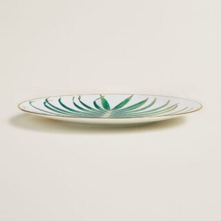 Hermes Passifolia Dinner Plate Palm shown on table | Kneen & Co