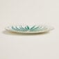 Hermes Passifolia Dinner Plate Palm shown on table | Kneen & Co