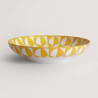 Hermès Soleil d’Hermès Large Deep Round Platter shown on table | Kneen & Co