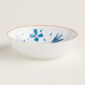 Hermes A Walk in the Garden Cereal Bowl shown on table| Kneen & Co
