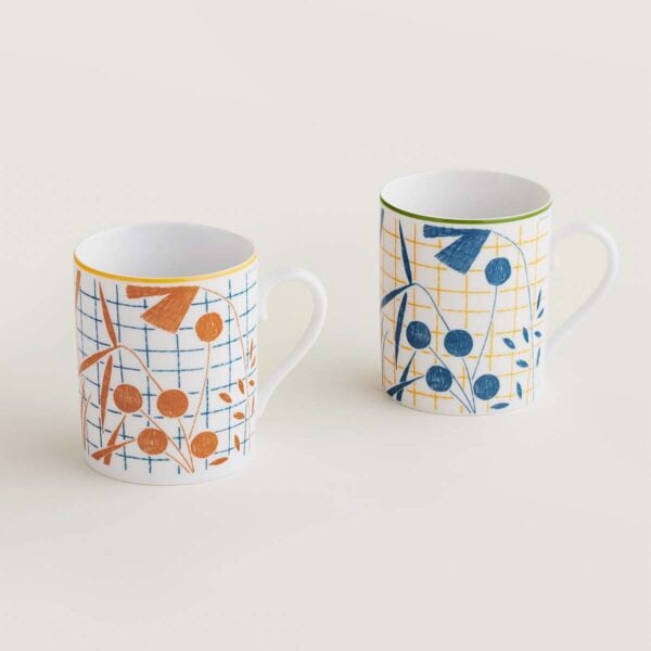 Hermes A Walk in the Garden Set of 2 mugs blue and orange shown on table | Kneen & Co