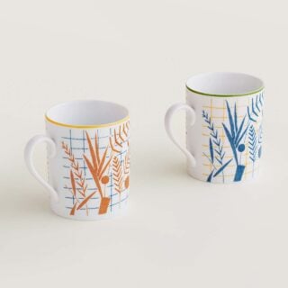 Hermes A Walk in the Garden Set of 2 mugs blue and orange shown on table | Kneen & Co