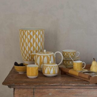 Hermès Soleil d’Hermès Dinnerware decoratively set on table | Kneen & Co
