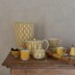 Hermès Soleil d’Hermès Dinnerware decoratively set on table | Kneen & Co