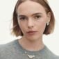 Woman wearing Georg Jensen Daisy Four Flower Necklace in 18 kt plated sterling silver and white enamel | Kneen & Co