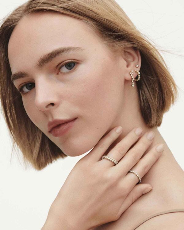 Woman wearing assorted Georg Jensen Signature Diamond earrings and rings | Kneen & Co