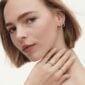 Woman wearing assorted Georg Jensen Signature Diamond earrings and rings | Kneen & Co