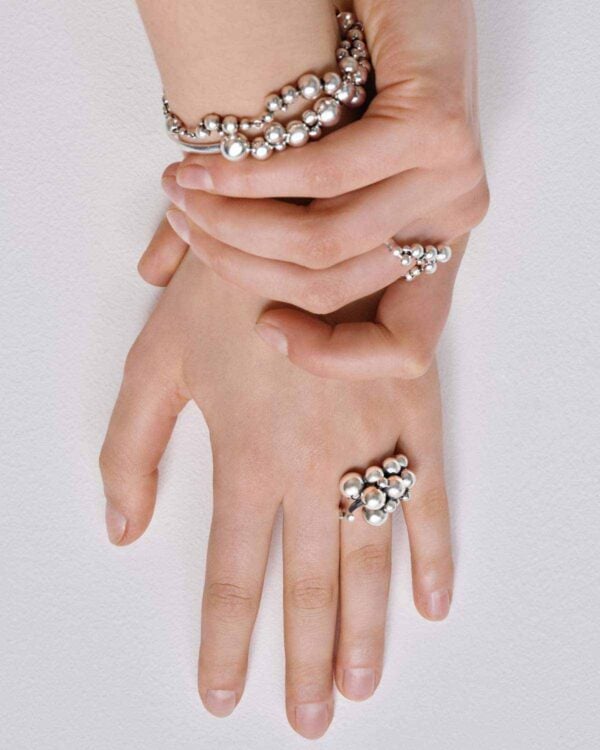 Woman wearing Georg Jensen Moonlight Grapes Bangle in sterling silver | Kneen & Co
