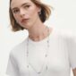 Woman wearing assortment of Georg Jensen Moonlight Grapes Sautoirs in sterling silver | Kneen & Co