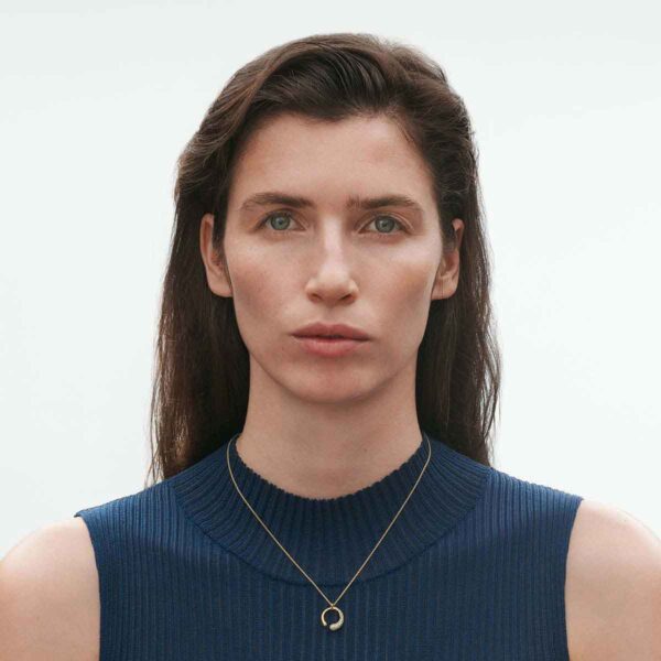 Woman wearing Georg Jensen Mercy Necklace with Pendant 0.33 CT in yellow gold with .33 ct of pavé diamonds | Kneen & Co