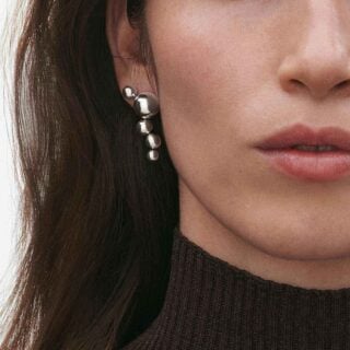 Woman wearing Georg Jensen Moonlight Grapes Earrings in sterling silver | Kneen & Co
