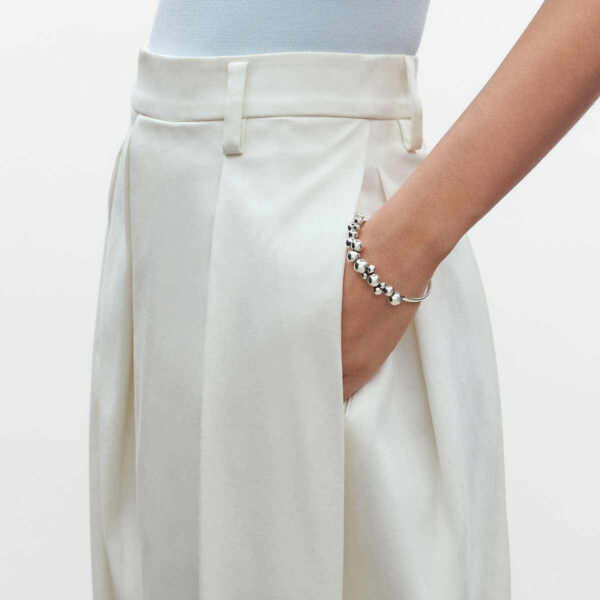 Woman wearing Georg Jensen Moonlight Grapes Bangle in sterling silver | Kneen & Co
