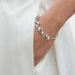 Woman wearing Georg Jensen Moonlight Grapes Bangle in sterling silver | Kneen & Co