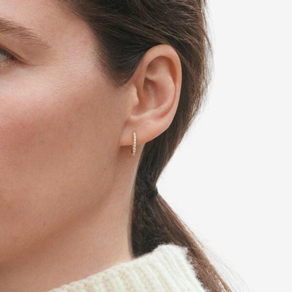 Woman wearing Georg Jensen Signature Diamonds Ear Hoop Gold with Diamonds 0.10 CT | Kneen & Co