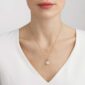 Woman wearing Georg Jensen Magic Necklace with Pendant in yellow gold | Kneen & Co