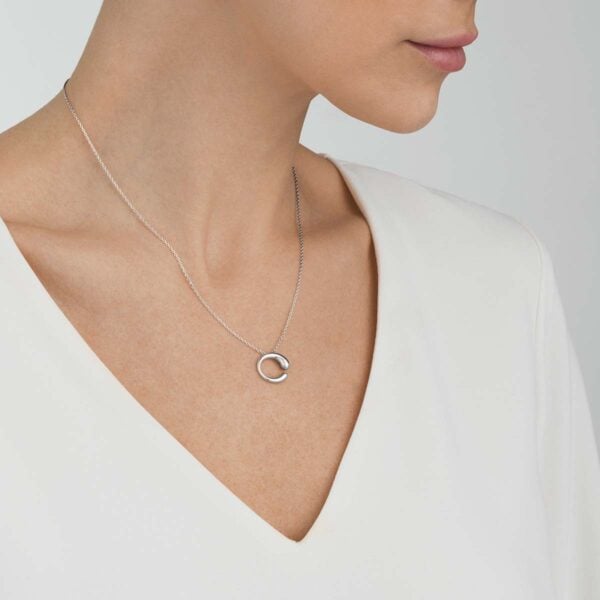 Woman wearing Georg Jensen Mercy Medium Pendant Necklace in sterling silver | Kneen & Co
