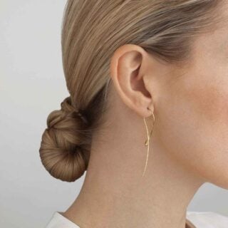 GJensen-10017826-MERCY-TWIST-EARRING-YG-1200w-100KB Woman wearing Georg Jensen Mercy Earrings in 18 kt yellow gold | Kneen & Co