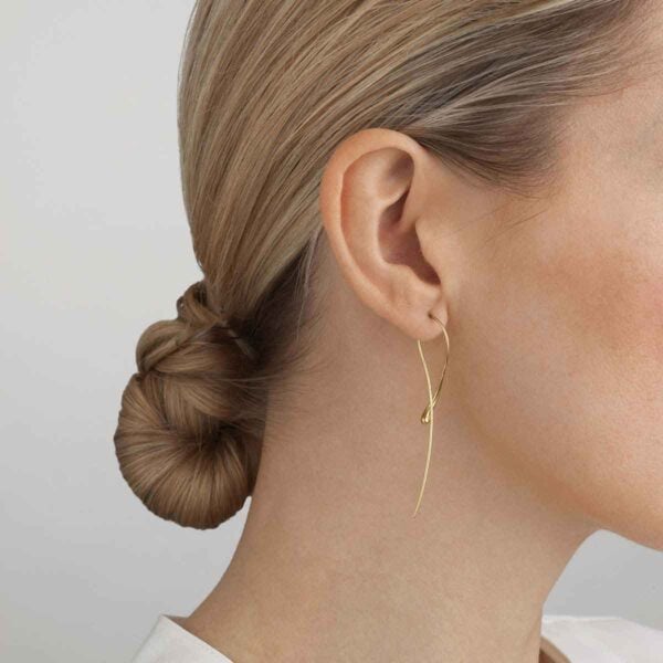 GJensen-10017826-MERCY-TWIST-EARRING-YG-1200w-100KB Woman wearing Georg Jensen Mercy Earrings in 18 kt yellow gold | Kneen & Co