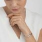 Woman wearing Georg Jensen Mercy Open Bangle in sterling silver | Kneen & Co