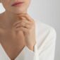 Woman wearing Georg Jensen Magic Ring in yellow gold | Kneen & Co