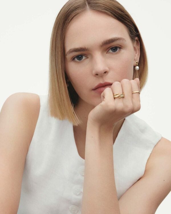 GJ-AW24-Magic-20000341-1200w-100KB Woman wearing Georg Jensen Magic Gold Earrings with pearls and diamonds and Magic gold rings. | Kneen & Co