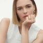 Woman wearing Georg Jensen Magic Gold Earrings with pearls and diamonds and Magic gold rings. | Kneen & Co