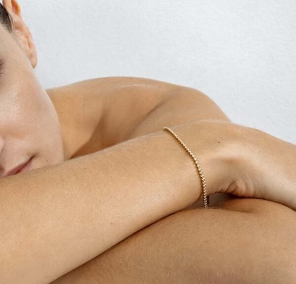 Woman wearing George Jensen Signature Diamonds Tennis Bracelet, Slim, Yellow Gold | Kneen & Co