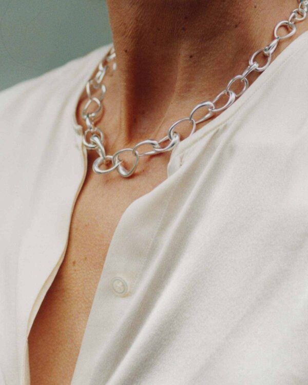 Woman wearing Georg Jensen Offspring Necklace in sterling silver | Kneen & Co