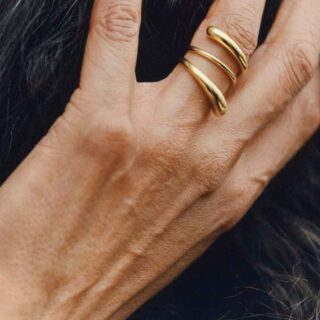 GJ-SS25-BRAND-CAMPAIGN-RABUN-20001406-4X5-1200w-100KB Georg Jensen Mercy Twist Ring in 18 kt yellow gold | Kneen & Co