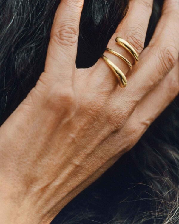 GJ-SS25-BRAND-CAMPAIGN-RABUN-20001406-4X5-1200w-100KB Georg Jensen Mercy Twist Ring in 18 kt yellow gold | Kneen & Co