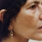 Woman wearing Georg Jensen Offspring Earrings in 18 kt yellow gold | Kneen & Co