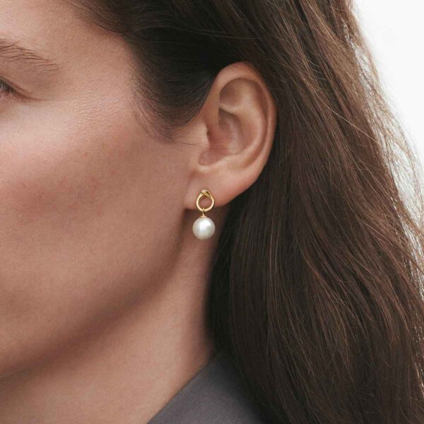 GJ-SS25-ECOM-SHOOT-MAGIC-EARRING-3519643-1-1200w-100KB Woman wearing Georg Jensen Magic Earrings Gold with Pearls and 0.04 CT Diamonds | Kneen & Co
