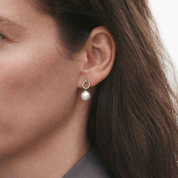 GJ-SS25-ECOM-SHOOT-MAGIC-EARRING-3519817-1-1200w-100KB Woman wearing Georg Jensen Magic Earrings White Gold with Pearls and 0.04 CT Diamonds | Kneen & Co