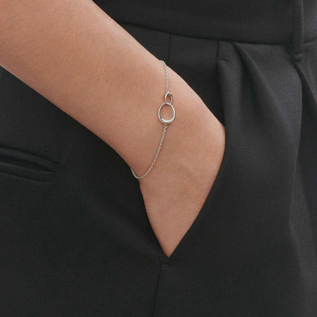 Georg Jensen Offspring Interlocking Bracelet in sterling silver close up on model | Kneen & Co