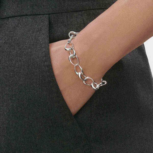 Close up of Woman wearing Georg Jensen Offspring Bracelet in sterling silver | Kneen & Co