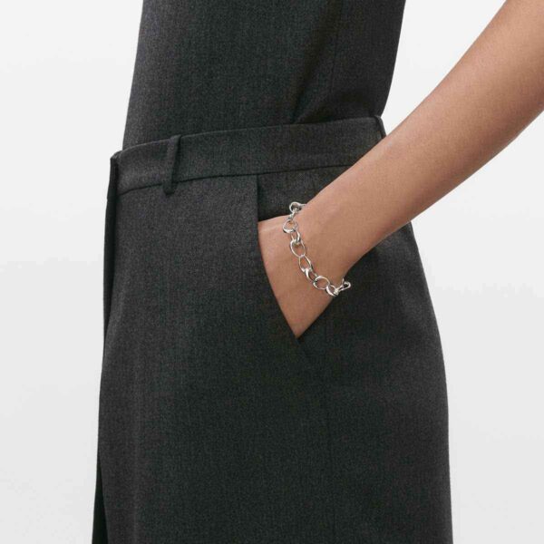 Woman wearing Georg Jensen Offspring Bracelet in sterling silver | Kneen & Co